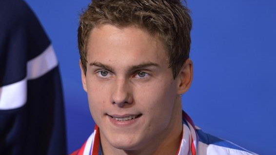 Russian swimmer Vladimir Morozov displays his gold medal during the podium ceremony for the men's 100m freestyle finalat the European Swimming Championships on November 24, 2012, in Chartres. AFP PHOTO ERIC FEFERBERG