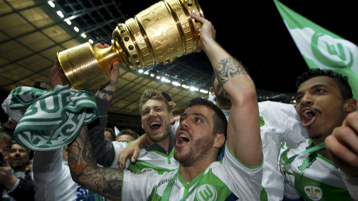 VfL Wolfsburg's Vieirinha holds up trophy as he celebrates winning German Cup final soccer match against Borussia Dortmund in Berlin