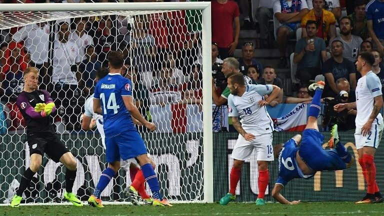 England's goalkeeper Joe Hart (L) saves a ball shot by Iceland's defender Ragnar Sigurdsson (2nd R) during Euro 2016 round of 16 football match between England and Iceland at the Allianz Riviera stadium in Nice on June 27, 2016. / AFP PHOTO / ANNE-CHRISTI