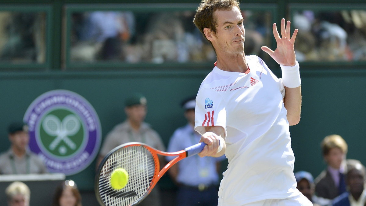 Andy Murray of Britain hits a return to Roger Federer of Switzerland in their men's singles final tennis match at the Wimbledon Tennis Championships in London