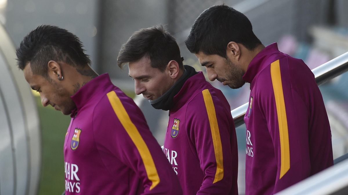 Barcelona's Brazilian forward Neymar da Silva Santos Junior (L), Barcelona's Uruguayan forward Luis Suarez (R) and Barcelona's Argentinian forward Lionel Messi arrive to take part in a training session at the Sports Center FC Barcelona Joan Gamper in Sant