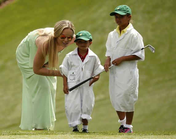 U.S. golfer Woods' girlfriend Vonn speaks with Woods' son Charlie and daughter Sam during the par 3 event held ahead of the 2015 Masters at Augusta National Golf Course in Augusta