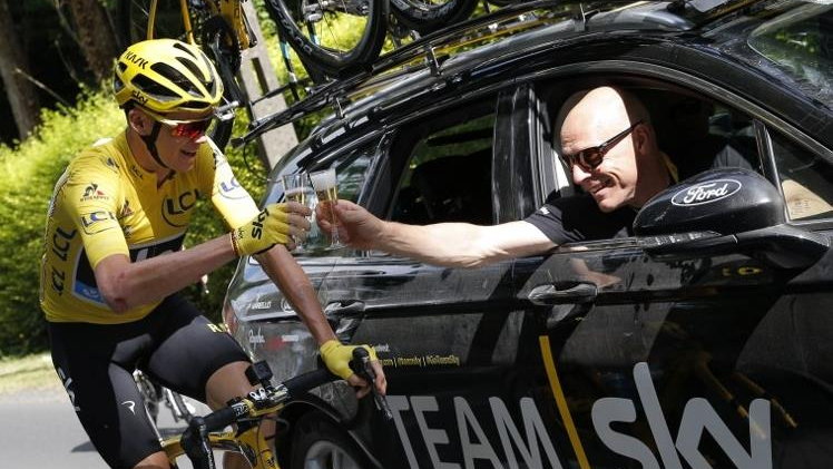 Christopher Froome (L), wearing the overall leader's yellow jersey, and Team Sky director Sir Dave Brailsford