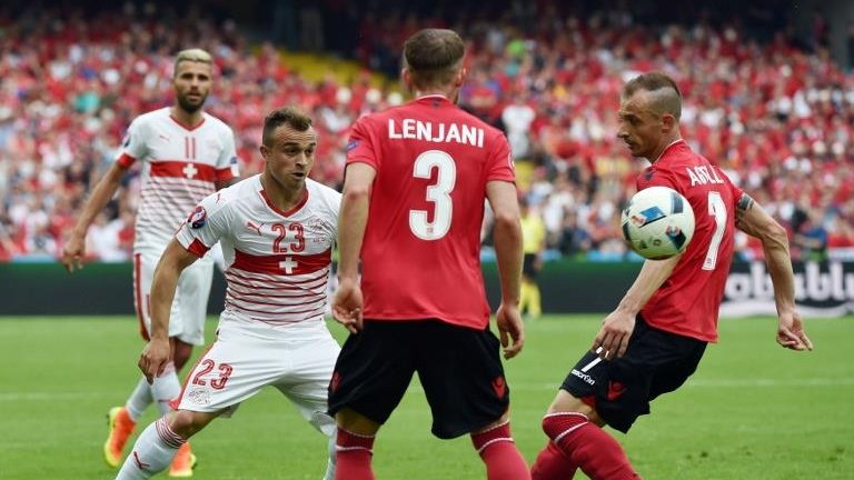 Albania's midfielder Ermir Lenjani (2nd R) and Albania's defender Ansi Agolli (R) vie with Switzerland's midfielder Xherdan Shaqiri (2nd L) during the Euro 2016 group A football match between Albania and Switzerland at the Bollaert-Delelis Stadium in Lens