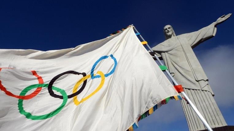 Handout picture released by Rio de Janeiro's governor office showing the Olympic flag at the Christ the Redeemer statue --Rio de Janeiro's